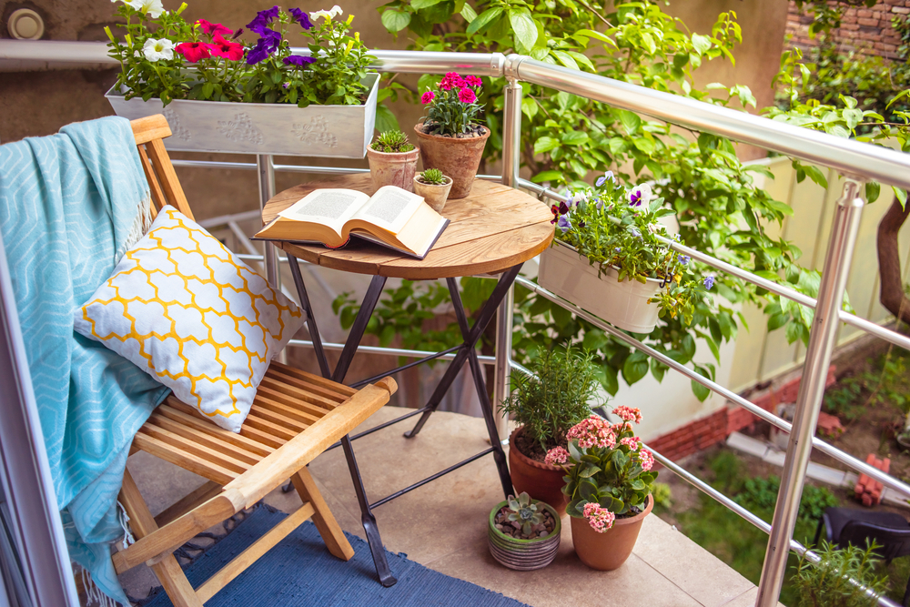 Beautiful terrace or balcony with small table, chair and flowers