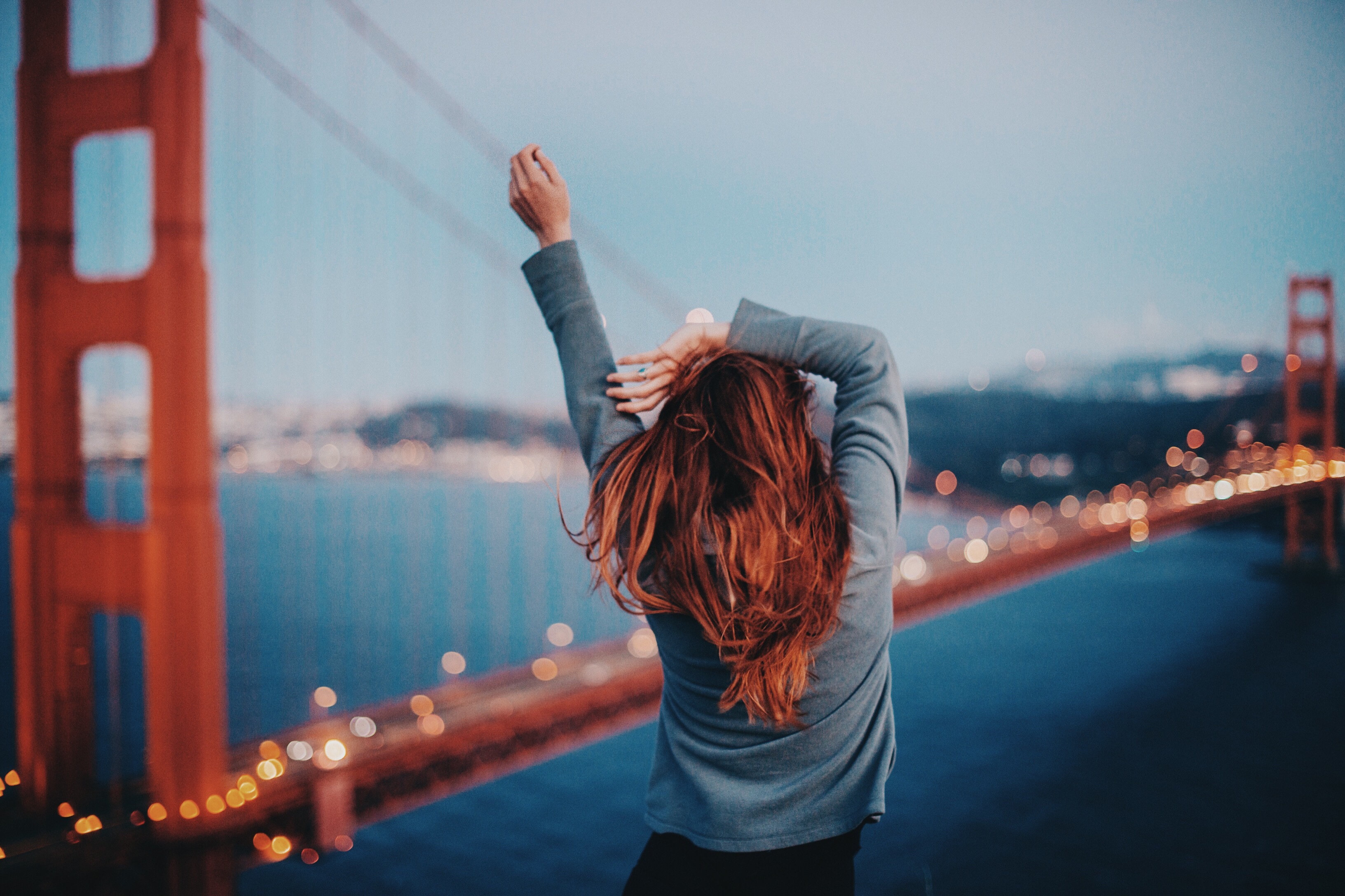 Woman poses in front of the Golden Gate Bridge in San Francisco, California.