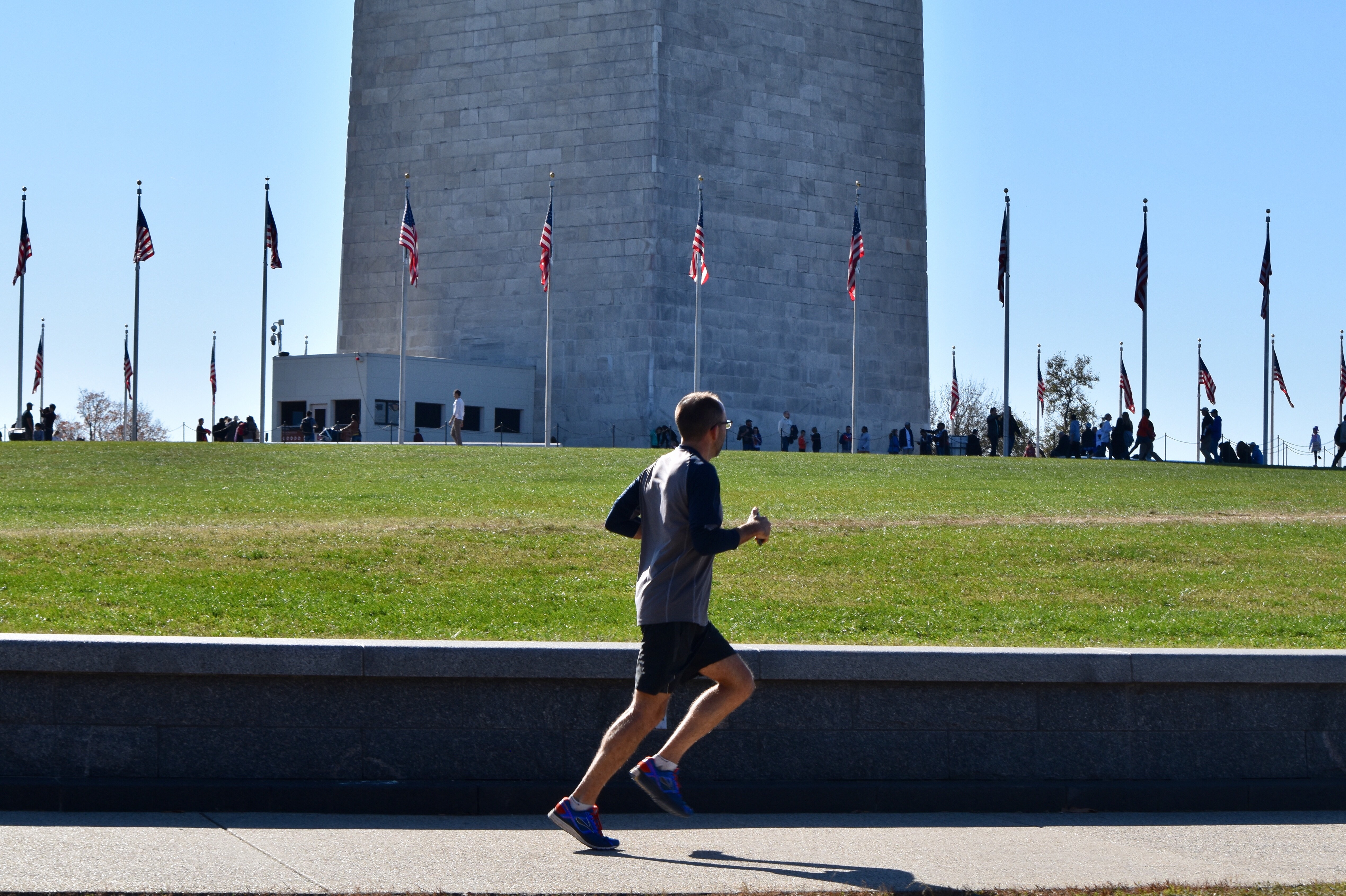 Man running along the path in front of the Washington Monument in Washington, D.C.