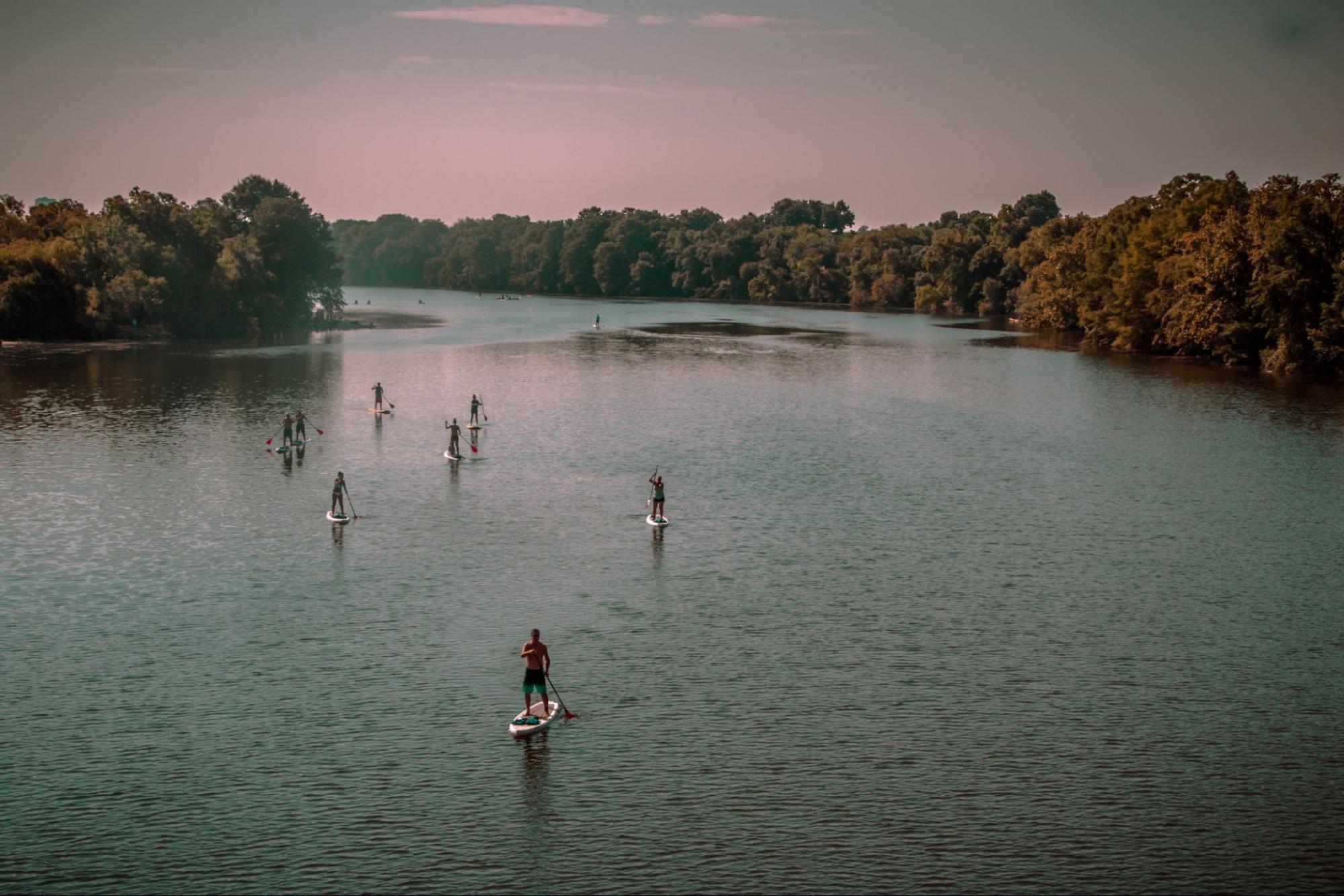 Kayakers and paddleboarders on Lady Bird Lake in Austin, Texas, during the summer.