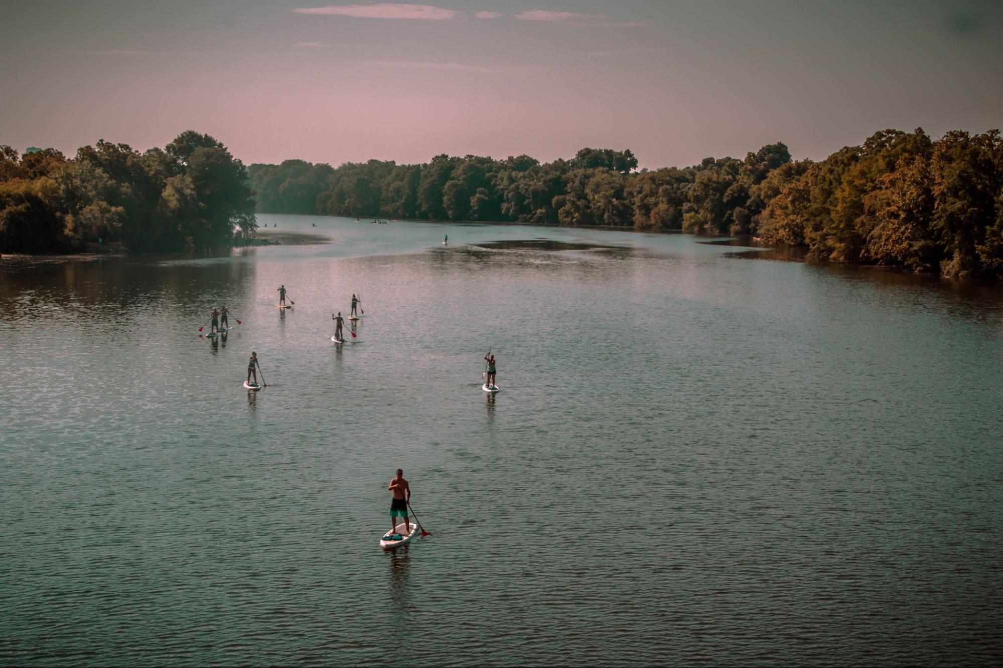 spending the summer in austin Kayakers and paddleboarders on Lady Bird Lake in Austin, Texas, during the summer.