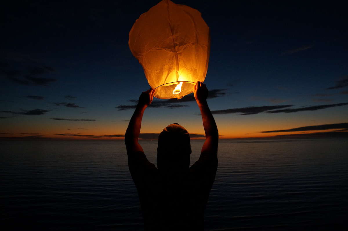 Man releases a lantern into the sky in San Diego, California.