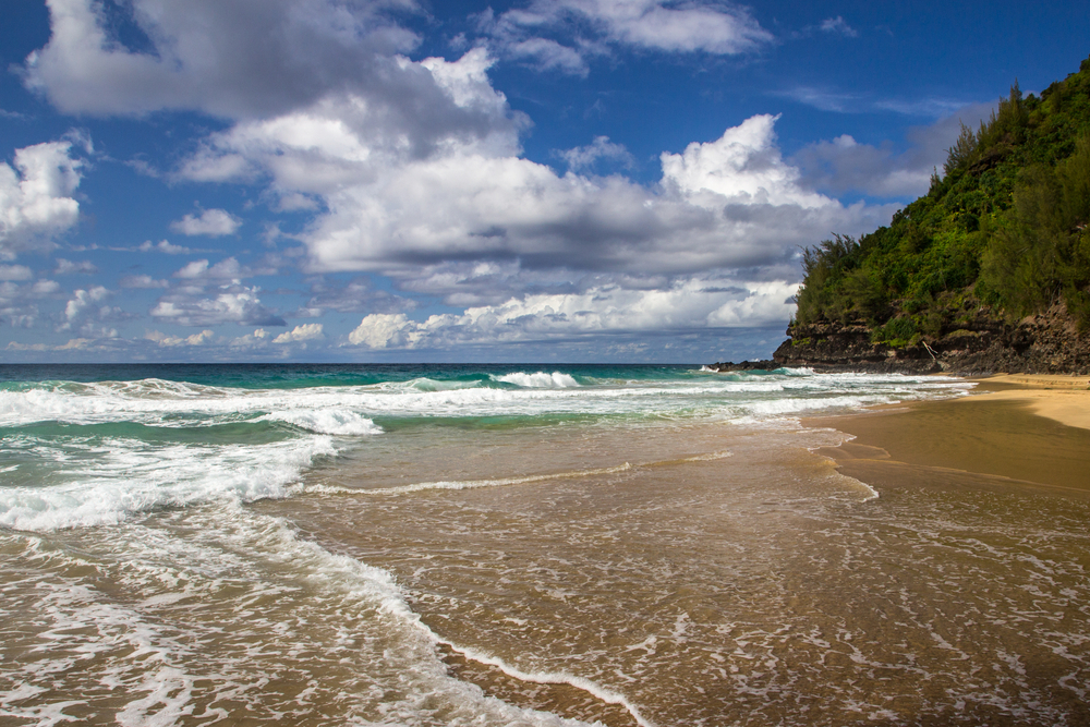 Shallow ocean water and waves on the beach in Hanakapi-ai beach, Napali, HonoOnapali Natural reserve Area, Kauai, Hawaii