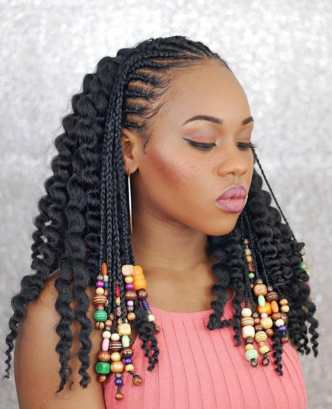 Woman looking down with braids with multi-colored beads