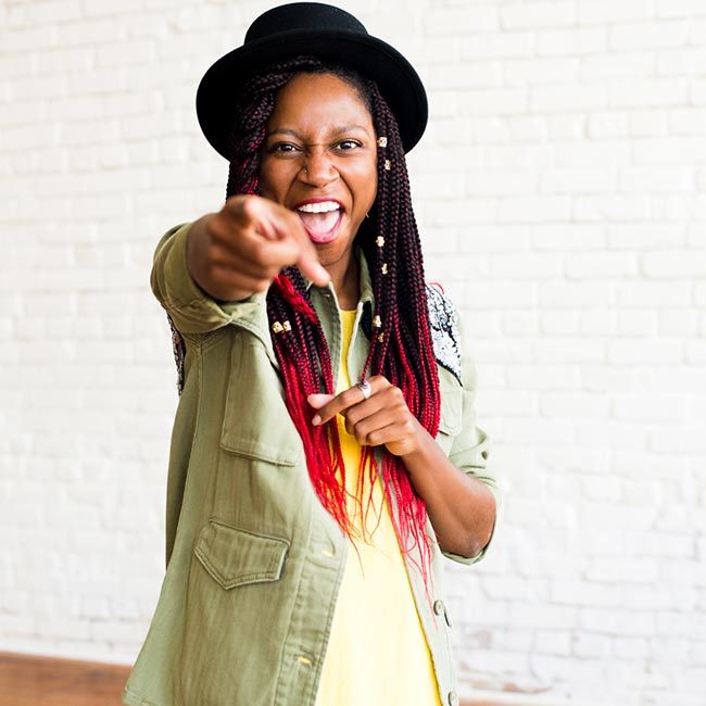 naturallycurly sr copywriter gerilyn hayes points at camera with enthusiasm